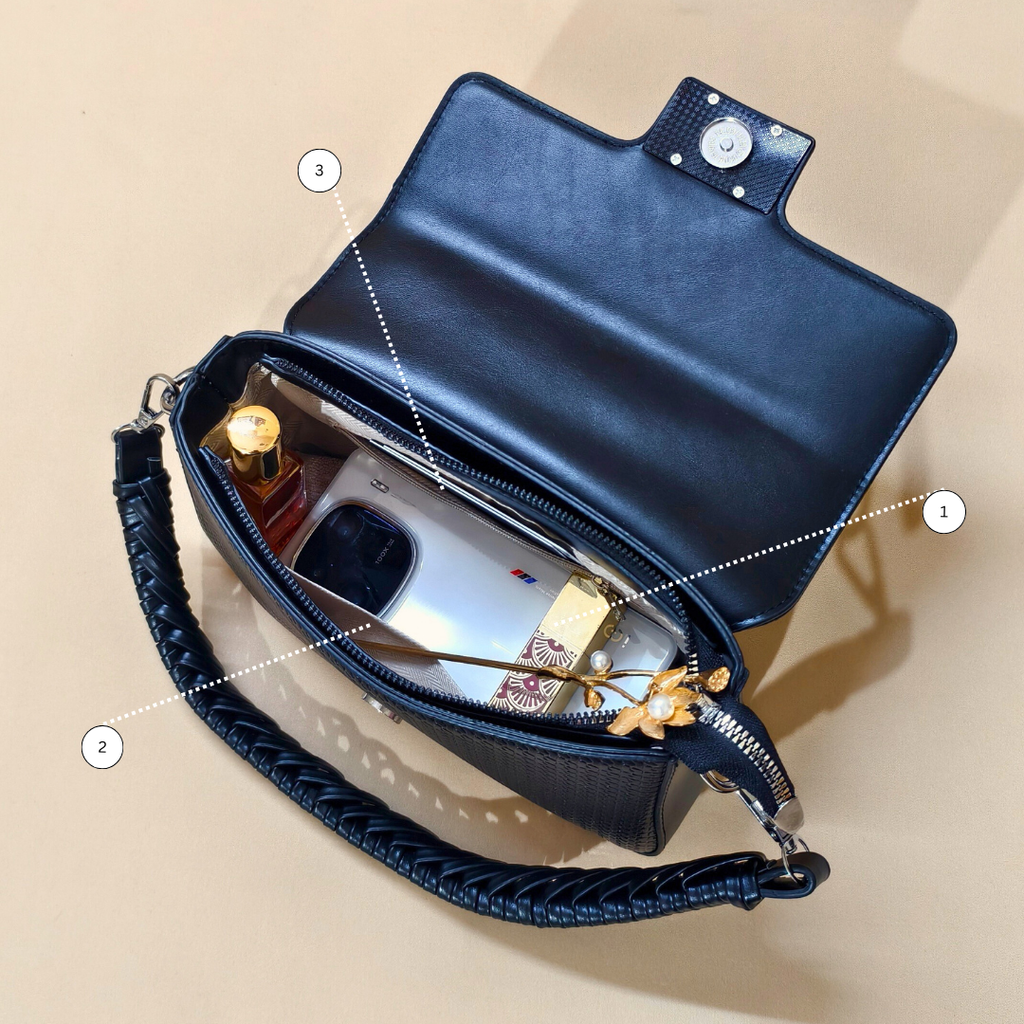 Navy blue handbag with interior details on a beige background