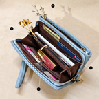 Open light blue wallet with organized compartments on a beige background