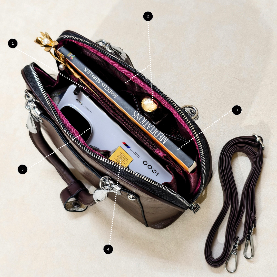 Open handbag with a wine bottle and accessories on a beige background