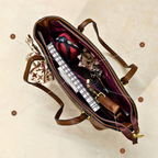 Brown leather bag with items inside on a beige background