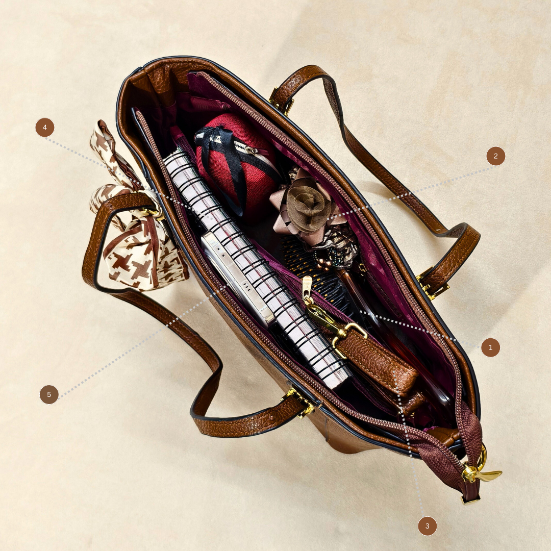 Brown leather bag with items inside on a beige background