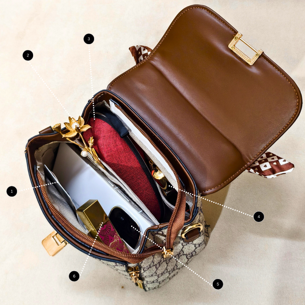 Open brown handbag with gold accents on a beige background