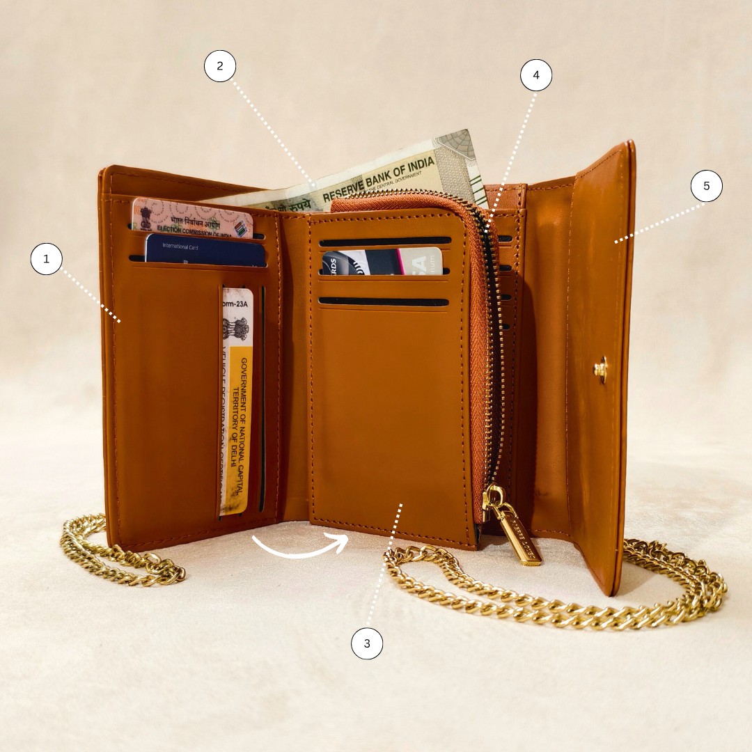 Brown leather wallet with gold chain on a beige background