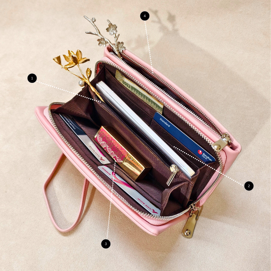 Pink wallet with compartments and items on a beige background