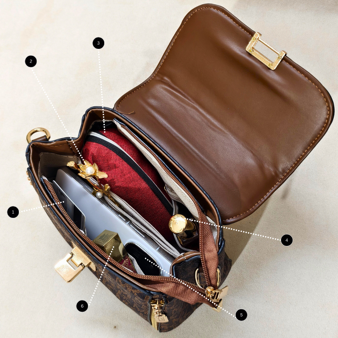 Brown leather handbag with gold accents on a beige background