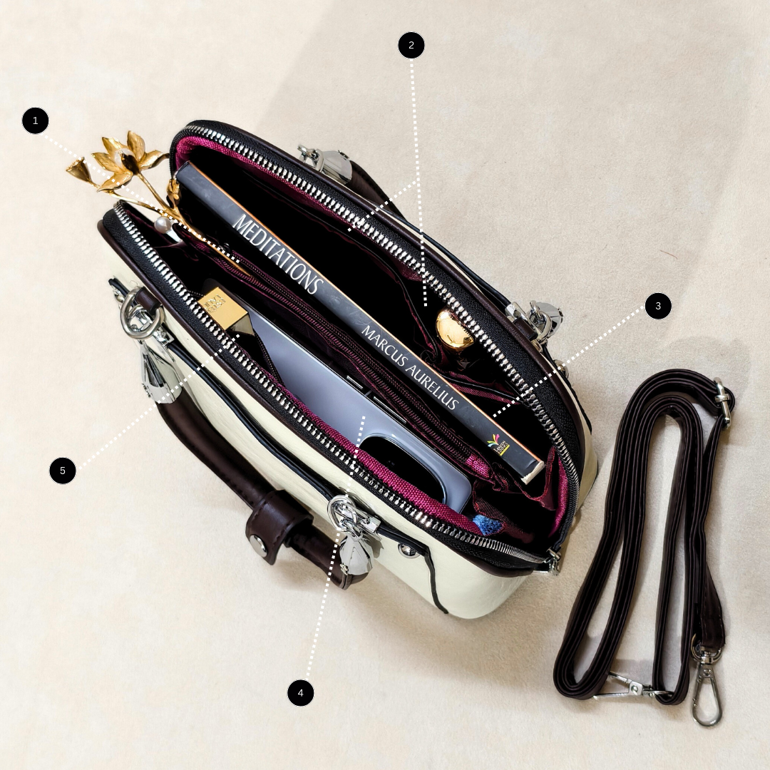 Open handbag with books inside on a light background