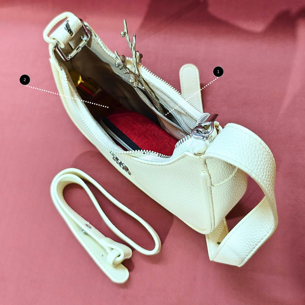 White handbag with a strap on a pink background