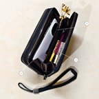 black wallet with an open compartment showcasing the capacity of the article in front of a neutral background