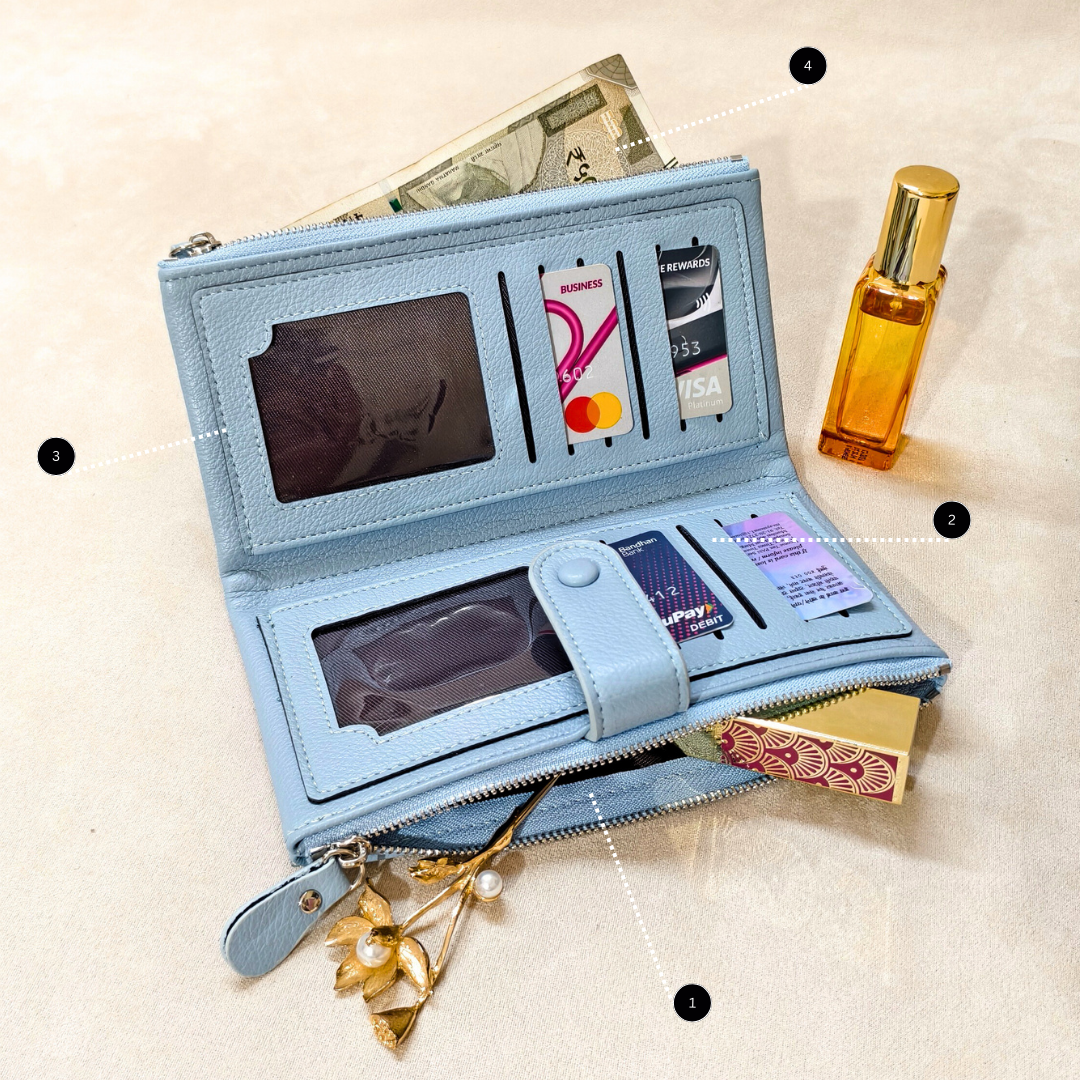 Blue wallet with various cards and a phone, placed on a light beige surface.