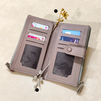 Open beige wallet with card slots on a light beige background