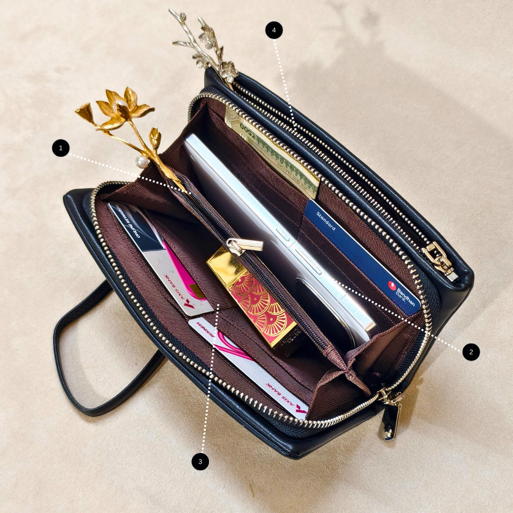 Open black wallet with gold accents on a beige background