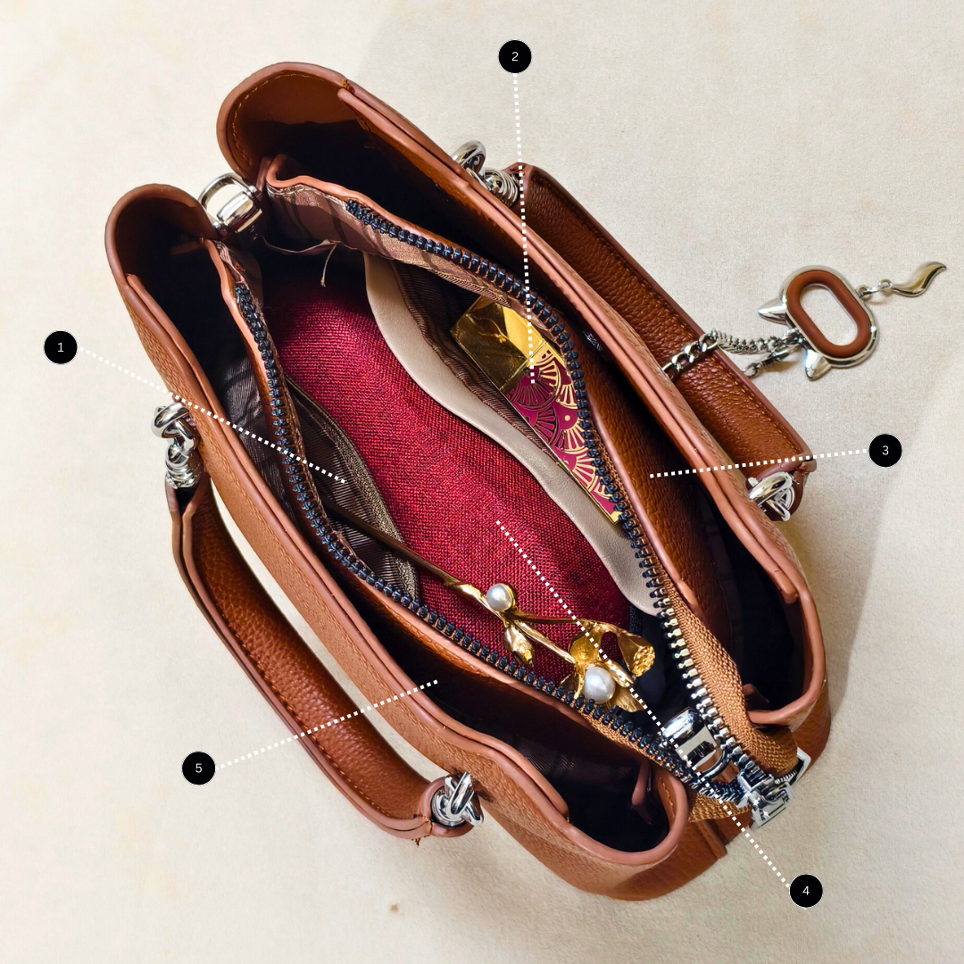 Brown leather handbag with jewelry on a beige background