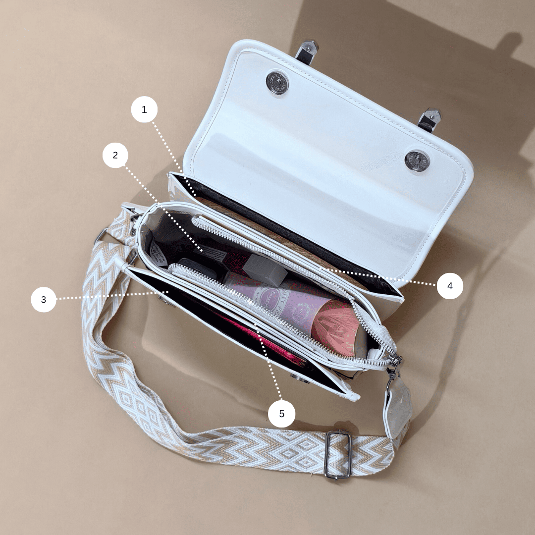 White handbag with a patterned strap on a beige background