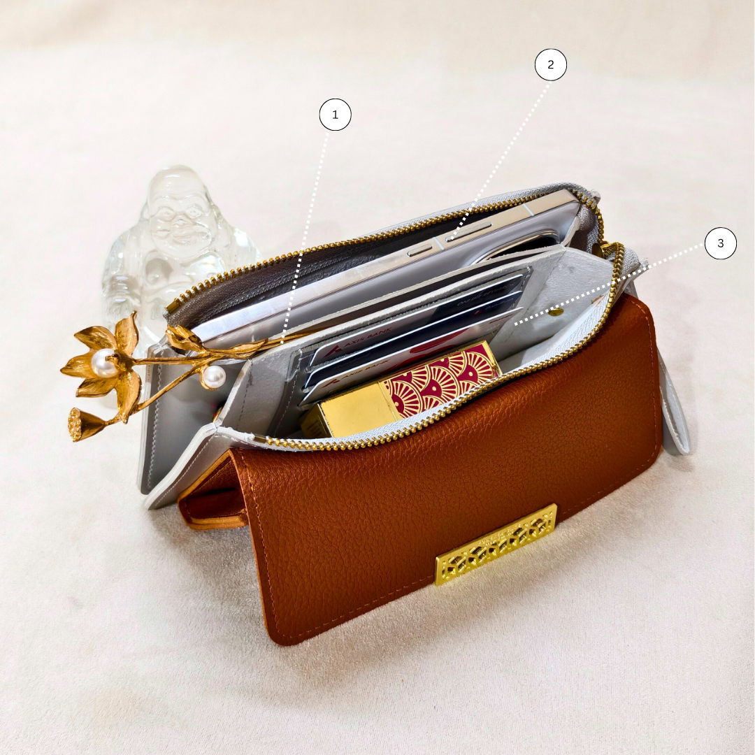 Brown leather wallet with card slots and a gold accent on a light background