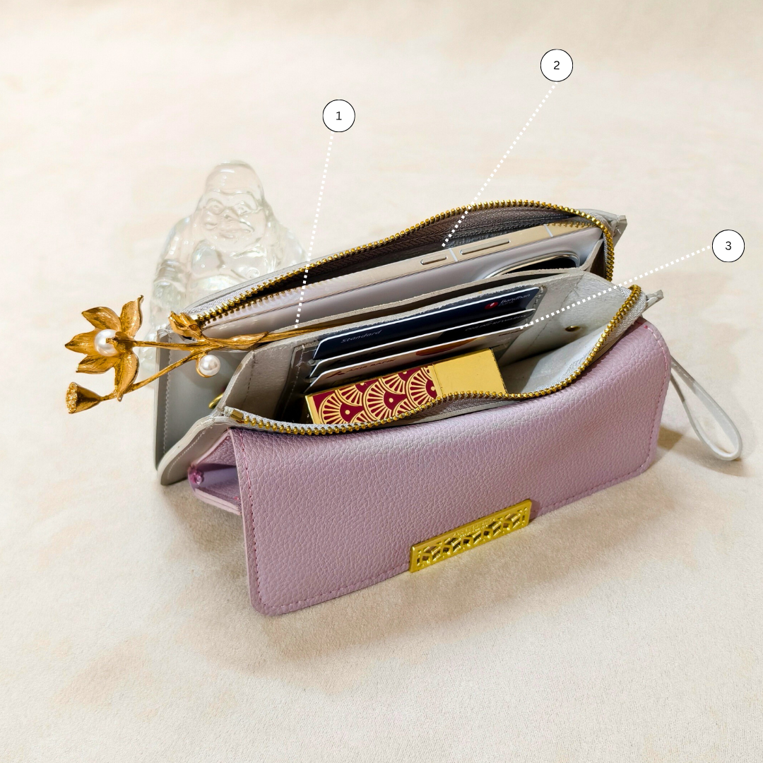 Pink wallet with gold accents on a light beige background