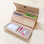 Open beige wallet with card slots and a phone pocket on a light background