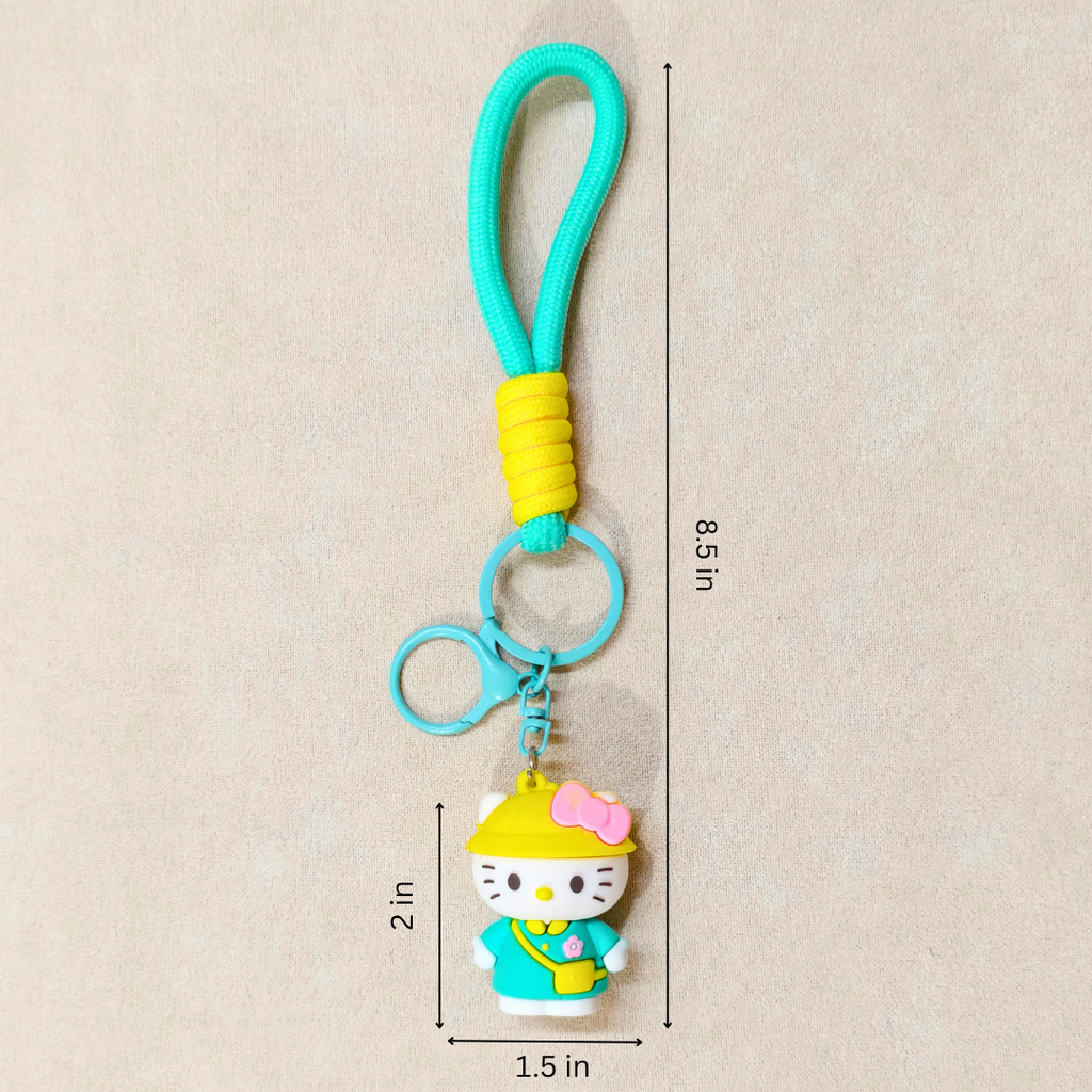 Keychain with a character in a yellow hat and blue outfit, measurements indicated on a beige background