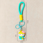 Keychain with a character in a yellow hat and blue outfit, measurements indicated on a beige background