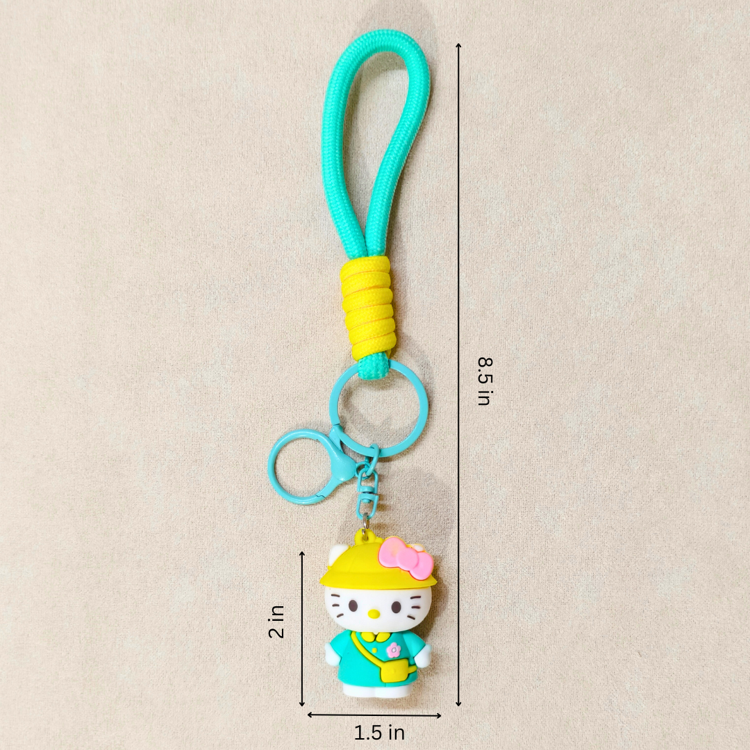 Keychain with a character in a yellow hat and blue outfit, measurements indicated on a beige background