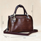 Brown handbag with dimensions labeled on a beige background