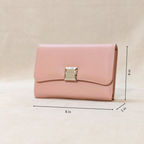 Pink wallet with gold clasp on a beige background, shown with measurements.