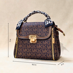 Designer handbag with visible brand logo and measurements on a beige background