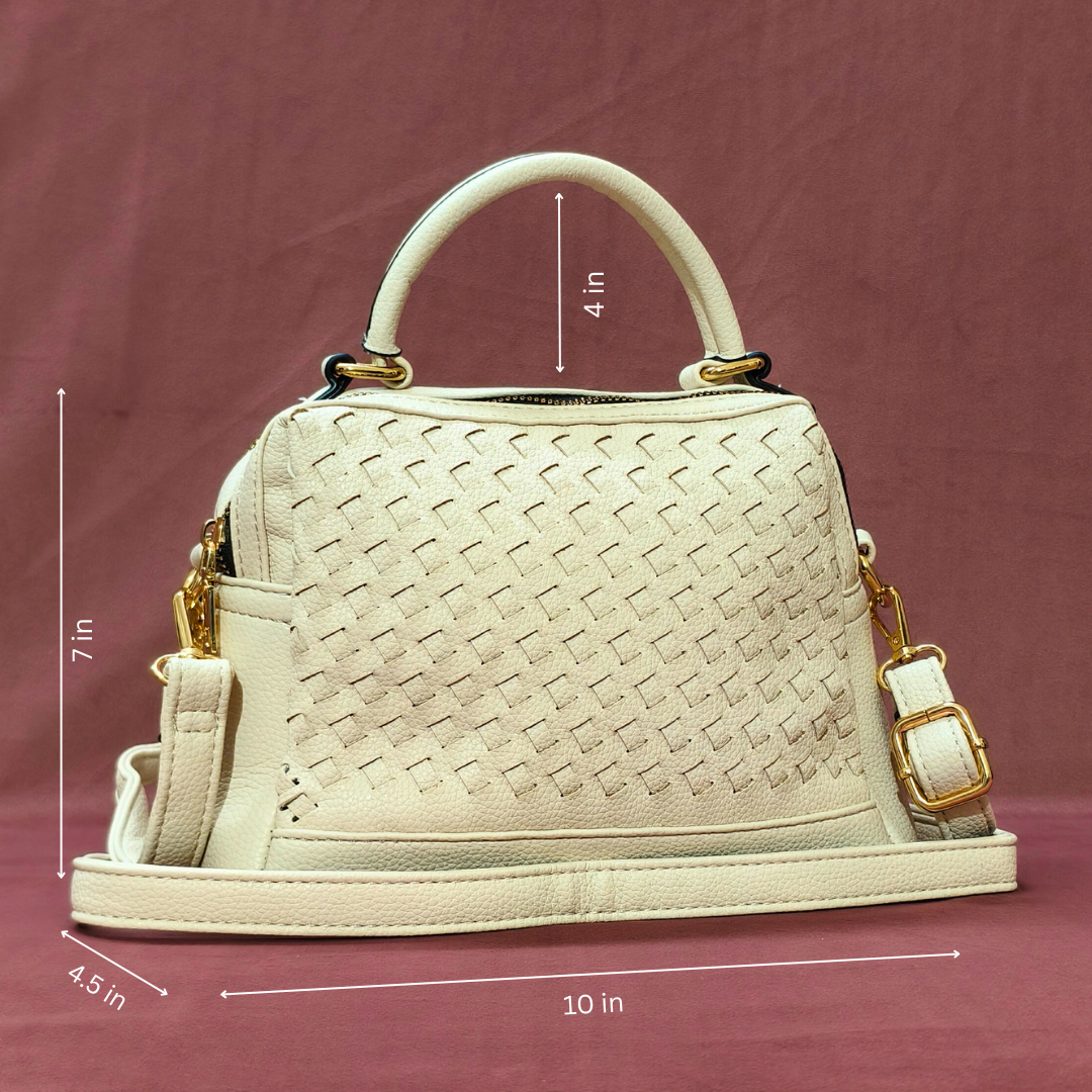Beige handbag with gold accents and measurements on a maroon background