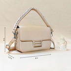 Beige handbag with braided handle on a beige background, featuring dimensions.