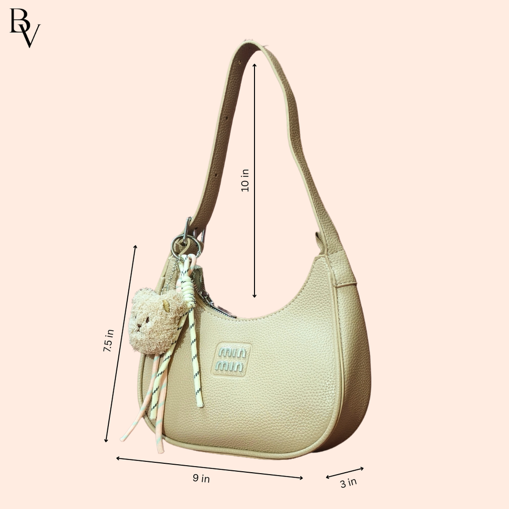 Beige handbag with measurements on a light pink background