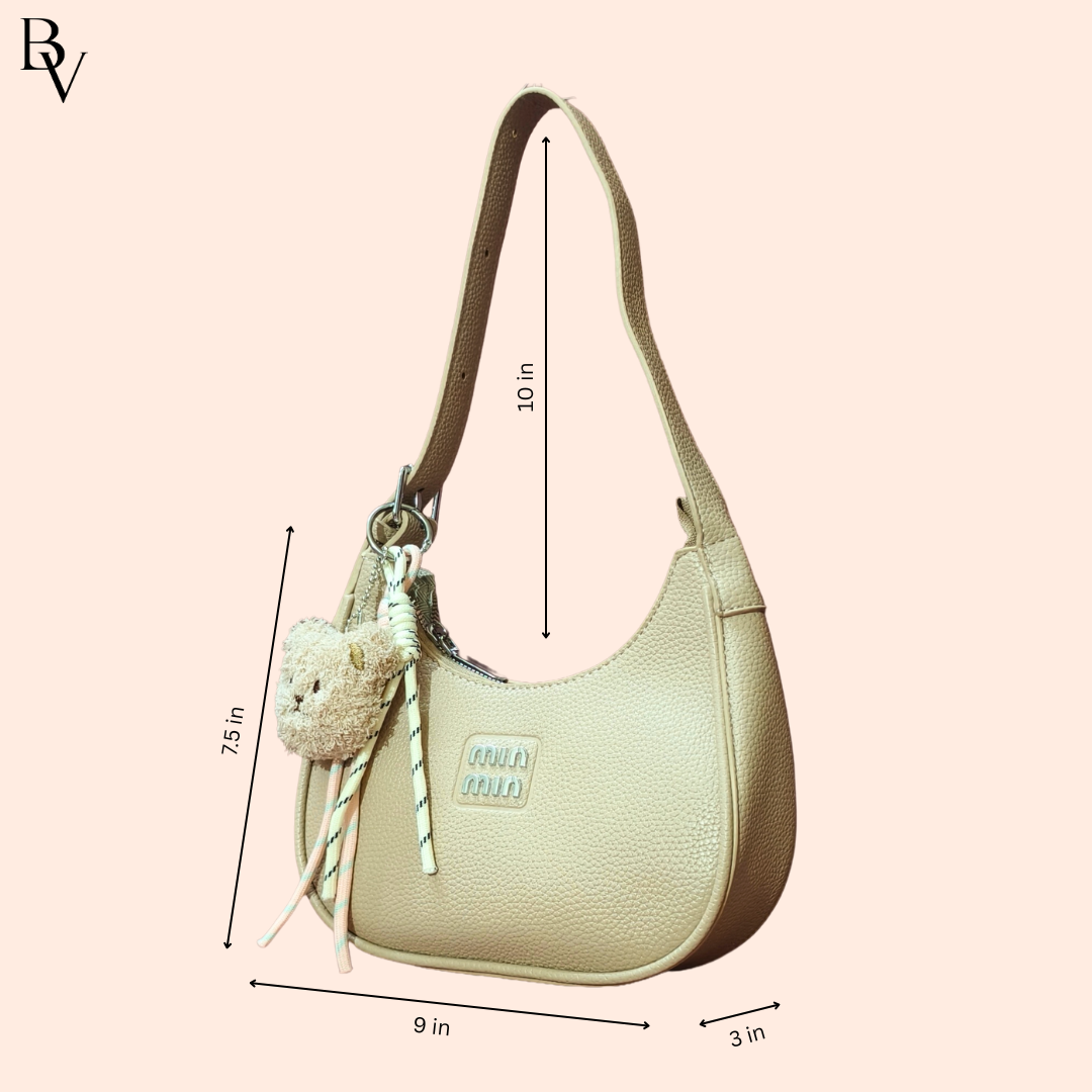 Beige handbag with measurements on a light pink background