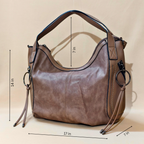 Brown handbag with measurements on a beige background