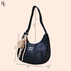 Black handbag with measurements on a beige background