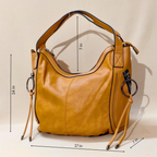 Yellow handbag with measurements on a beige background