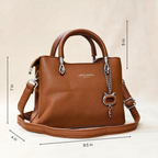 Brown handbag with measurements on a beige background