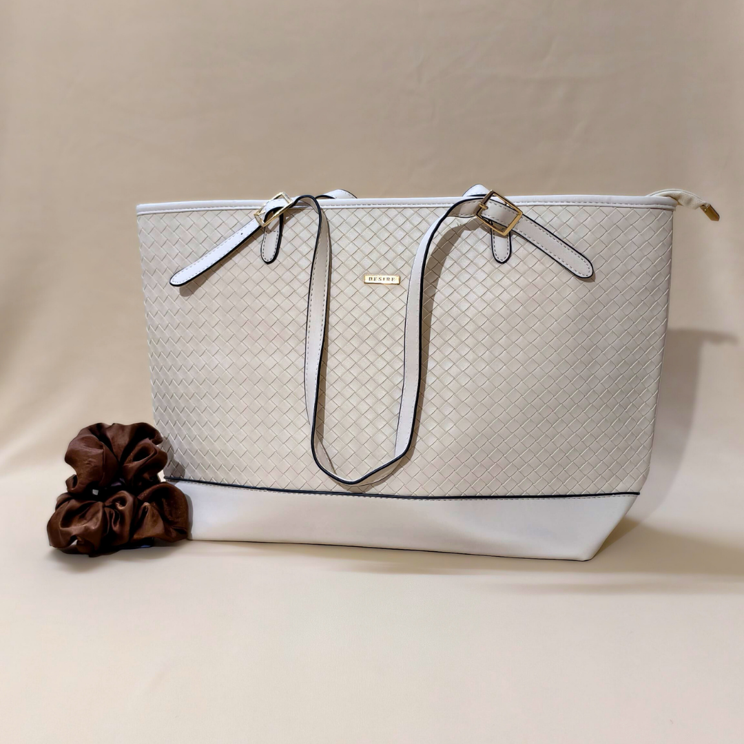 White handbag with woven pattern and brown flower on beige background