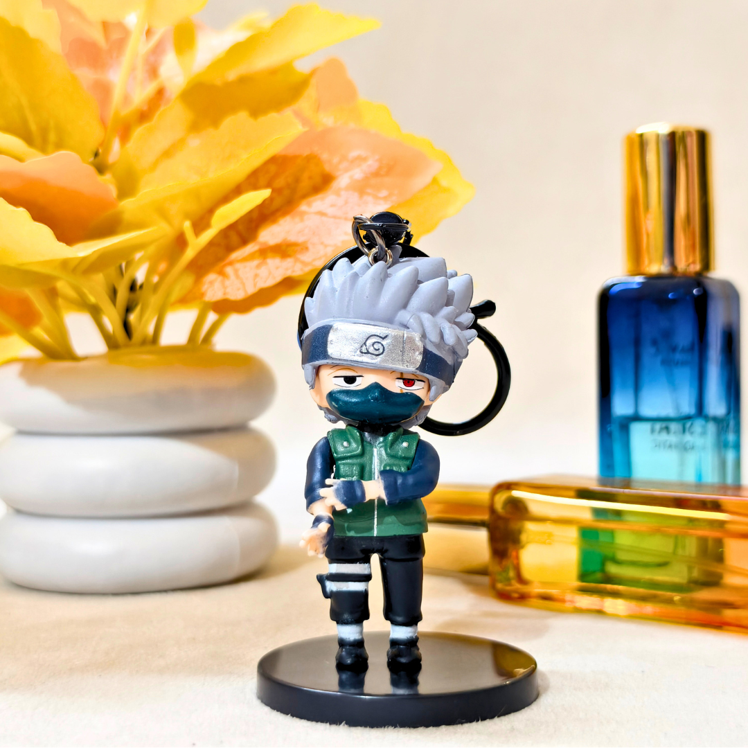 Keychain figure of a character from a popular anime series on a table with decorative elements.