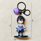 Keychain with a character figure and bell, shown with measurements on a beige background