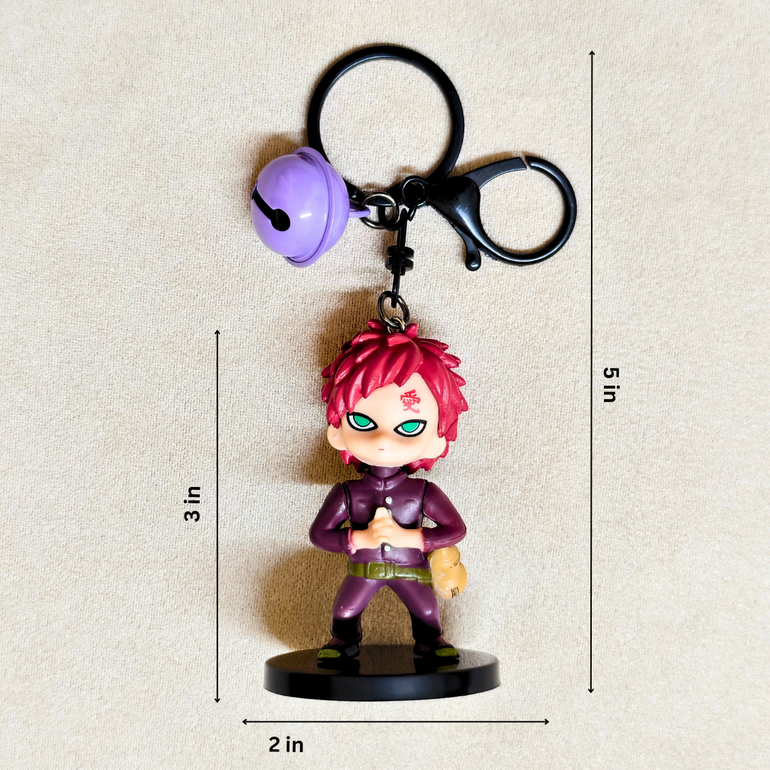 Keychain with a character figure and bell, shown with measurements on a beige background