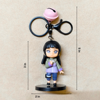 Keychain with a small figurine and bell on a beige background