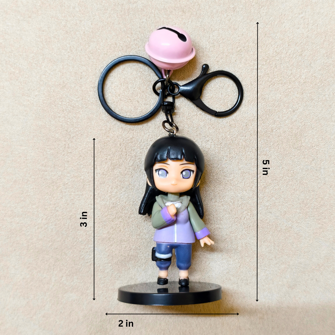 Keychain with a small figurine and bell on a beige background
