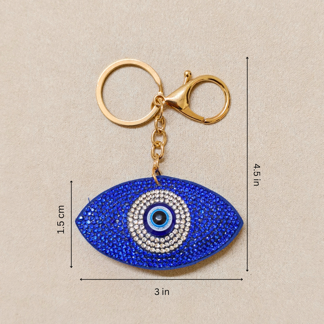 Blue eye-shaped keychain with gold clasp on a beige background